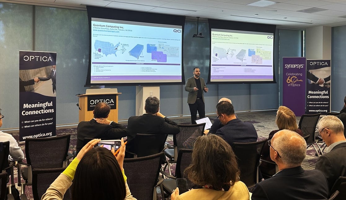 Dr. Pouya Dianat presenting the QCi TFLN Foundry at the 2024 Optica PECC Summit
