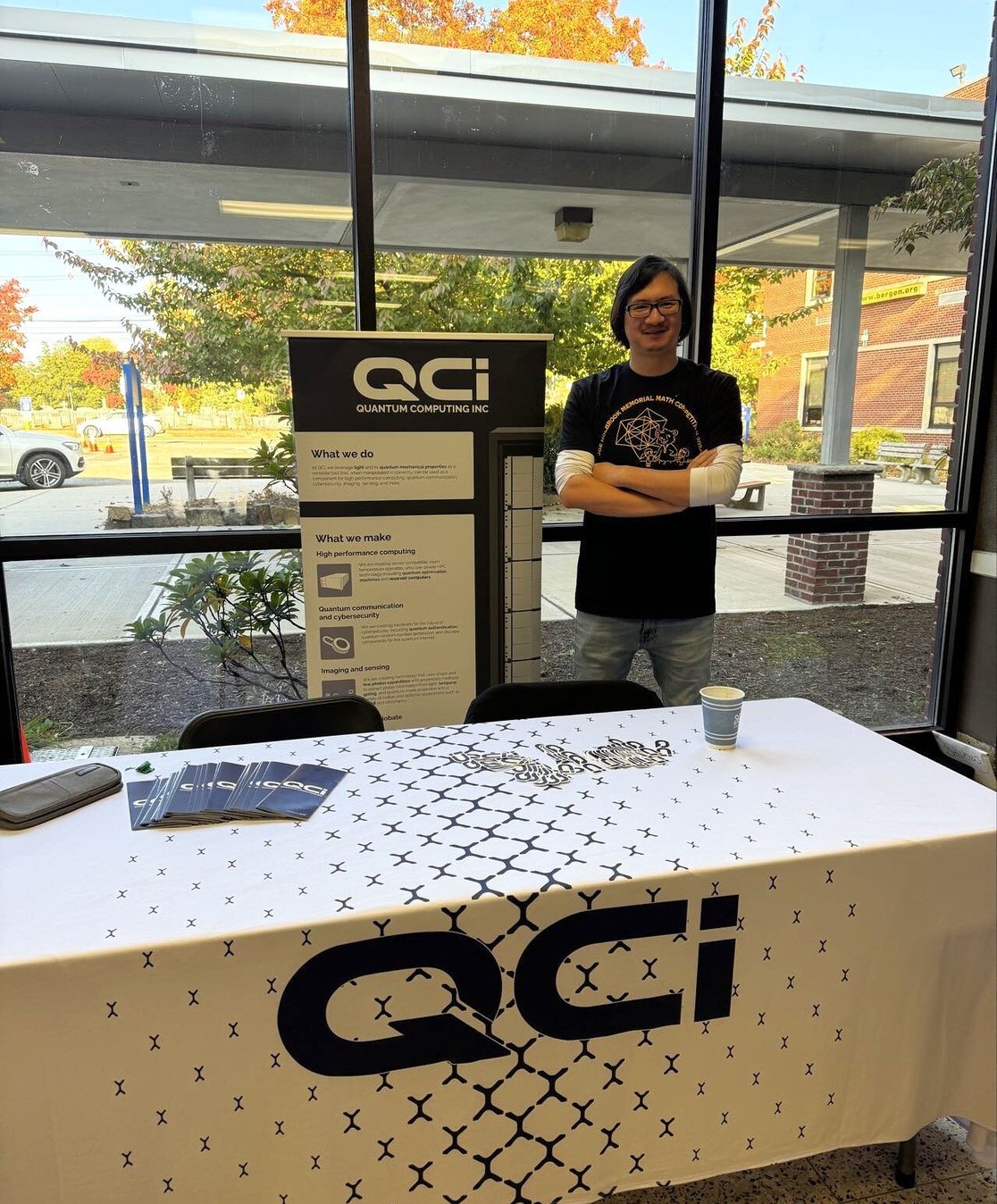 Dr. Yuping Huang at the QCi table at the 13th Annual Joel Holbrook Memorial Math Competition